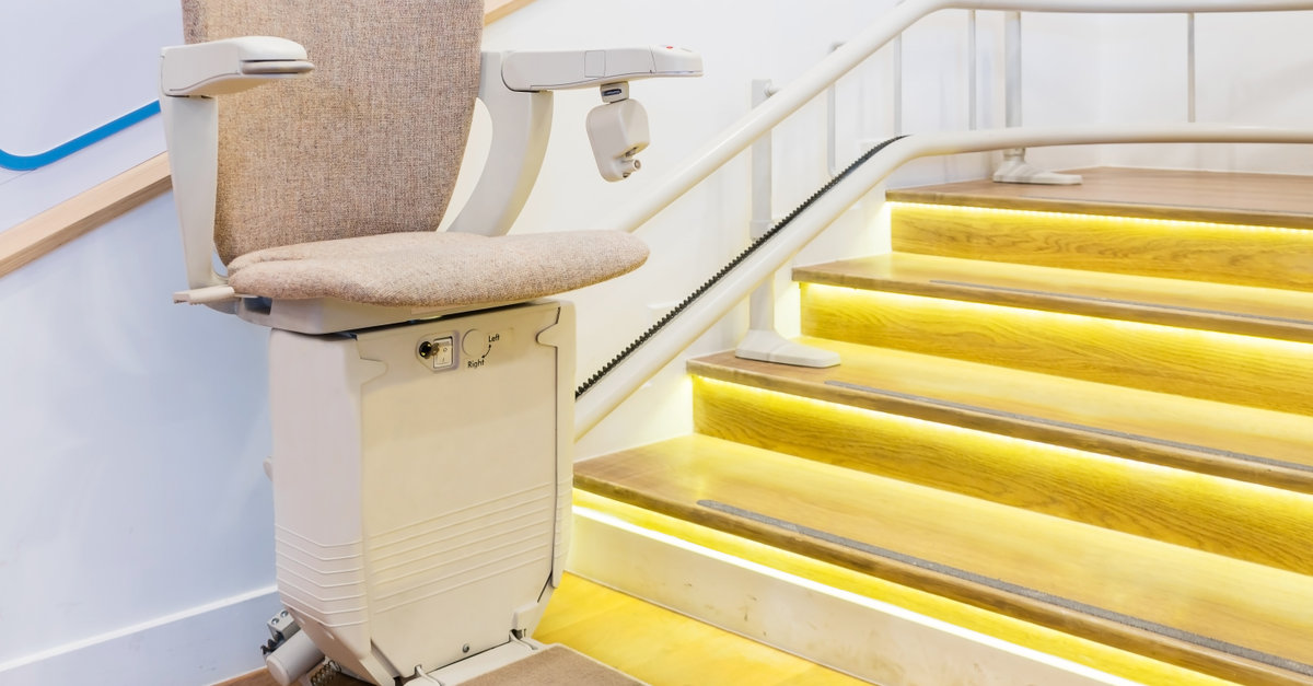 Stair lift on yellow staircase